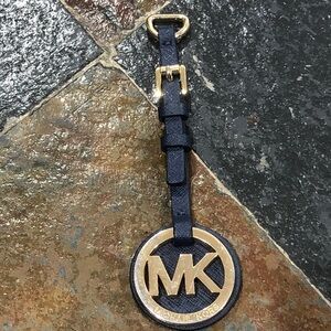 Michael Kors Gold MK Logo bag charmFOB with a navy blue Saffiano leather strap